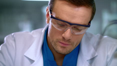 Scientist-corrects-glasses.-Portrait-of-scientist-focused-on-work